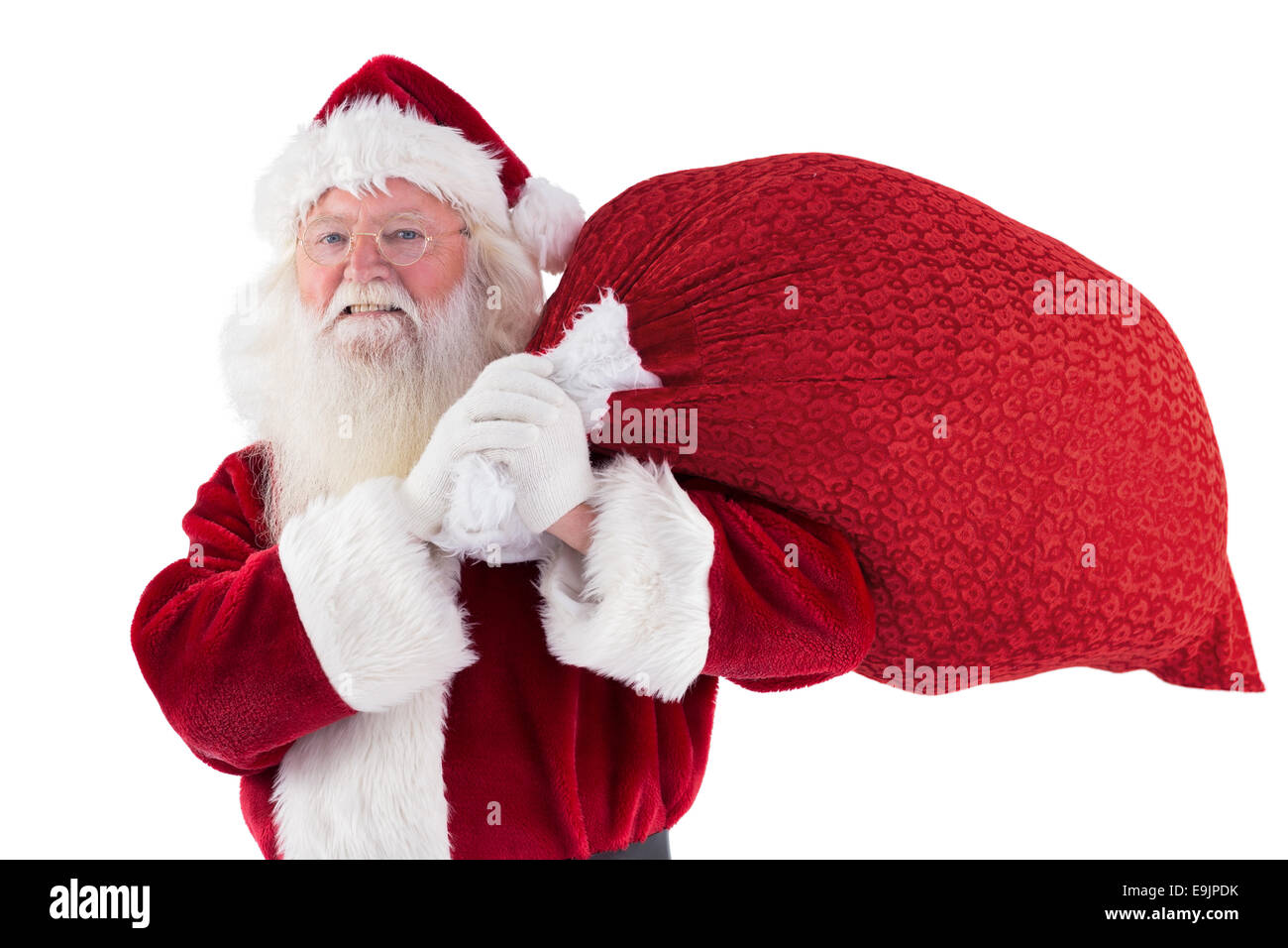 Santa carries his red bag and smiles Stock Photo - Alamy