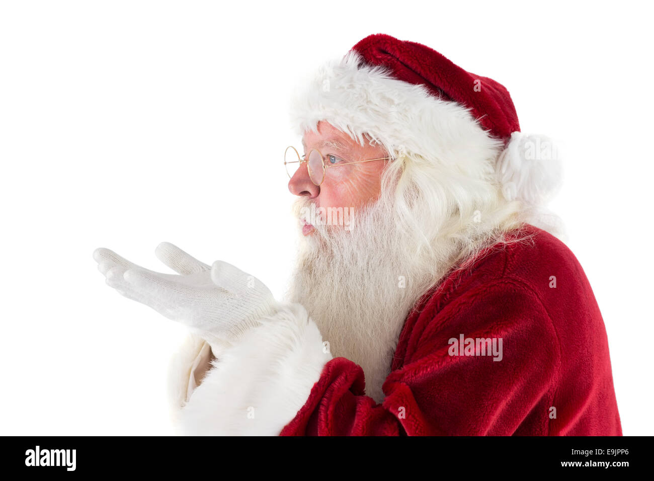 Santa Claus blows something away Stock Photo