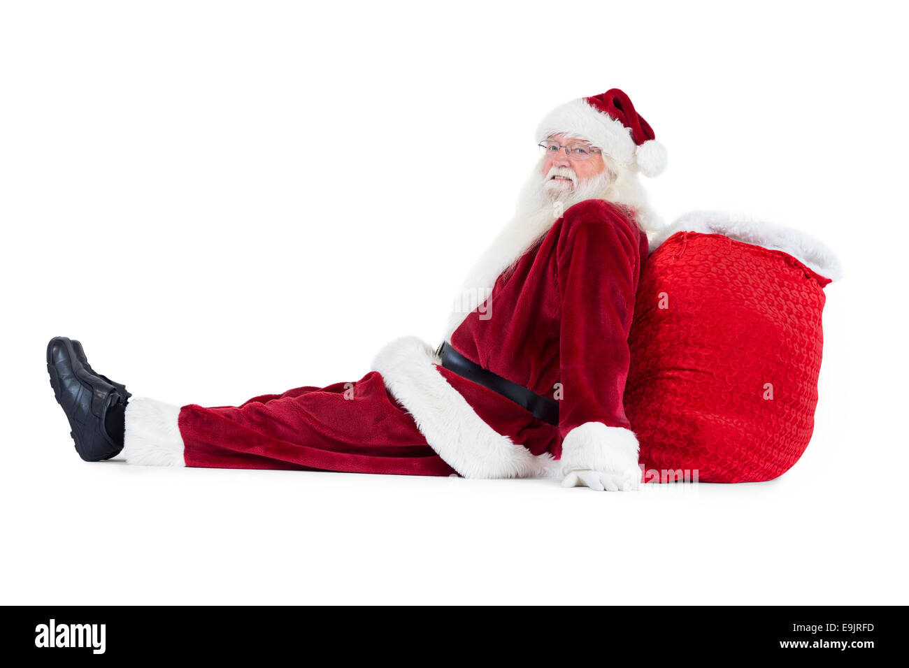 Santa sits leaned on his bag Stock Photo