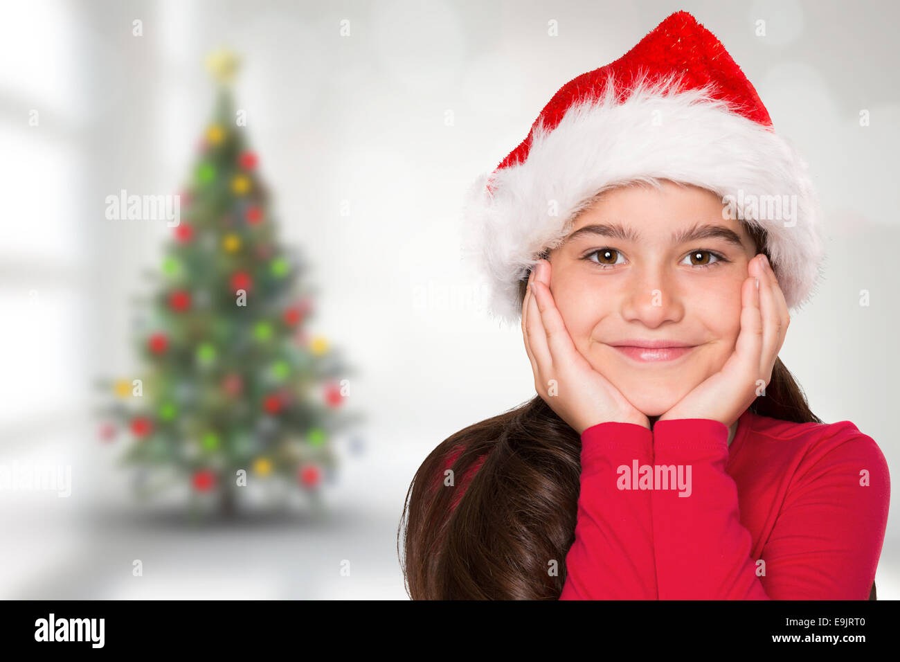 Composite image of festive little girl smiling at camera Stock Photo ...