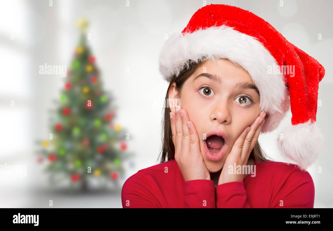 Composite image of festive little girl looking surprised Stock Photo