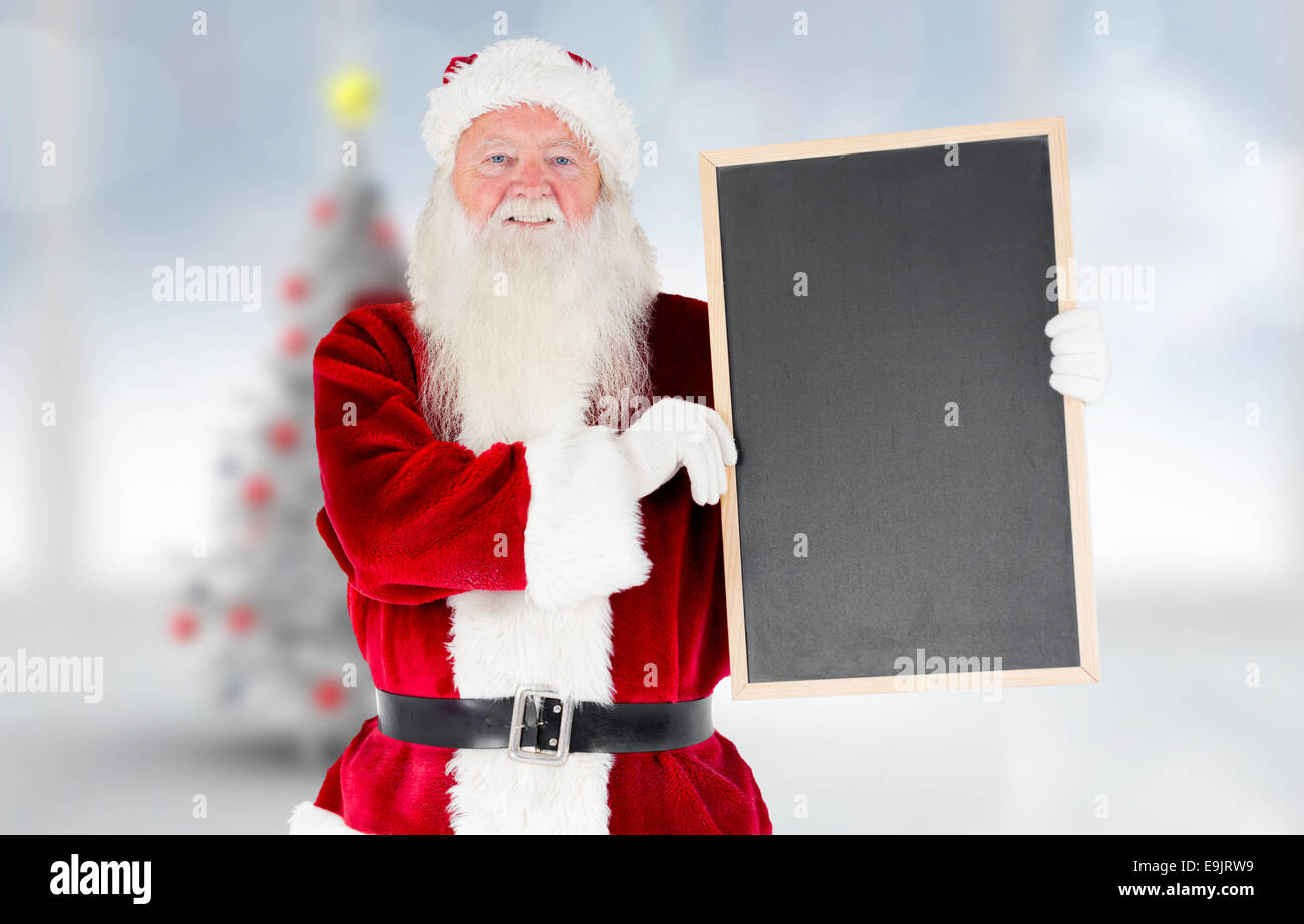 Composite image of santa claus showing blackboard Stock Photo - Alamy
