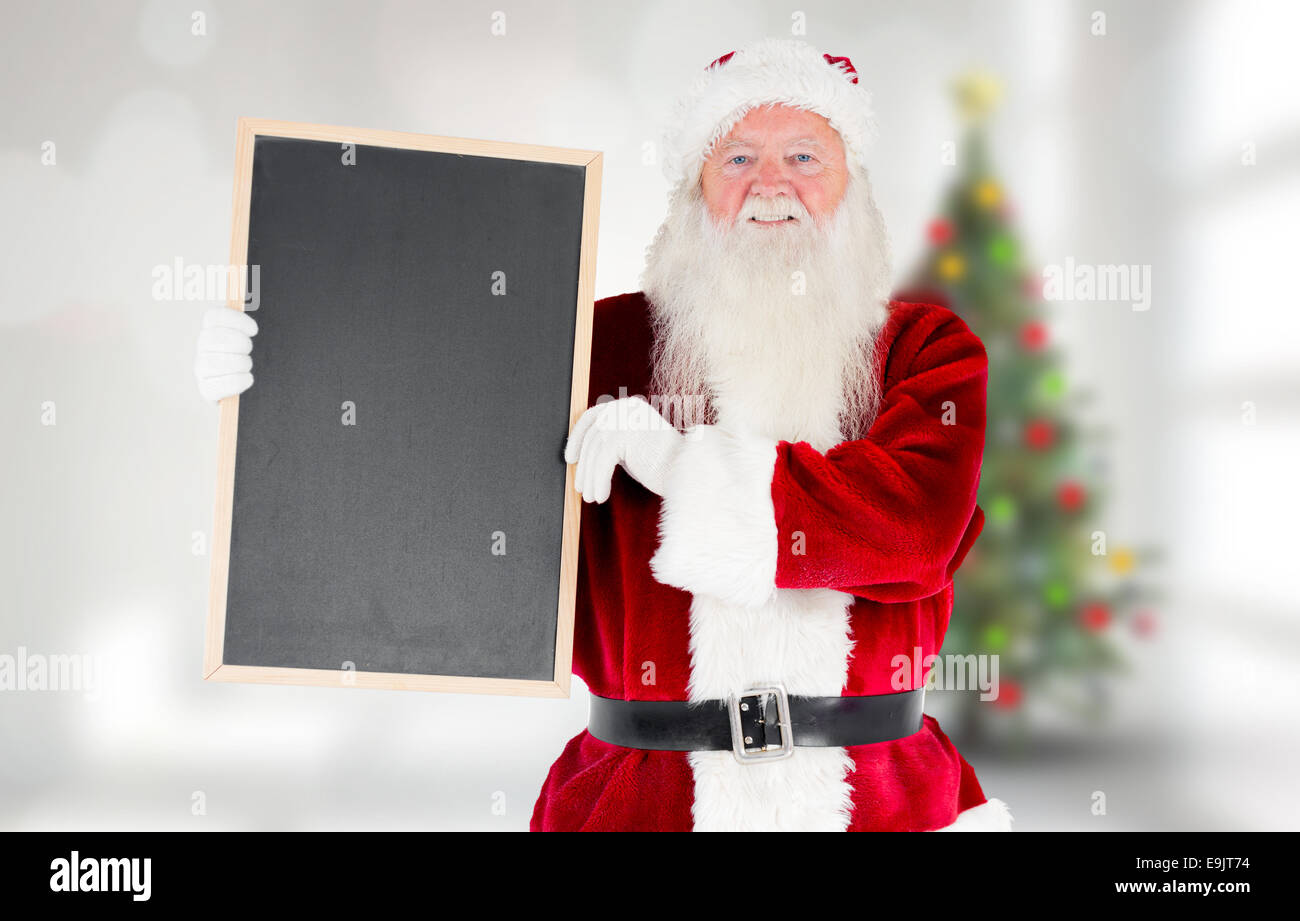 Composite image of santa claus showing blackboard Stock Photo - Alamy