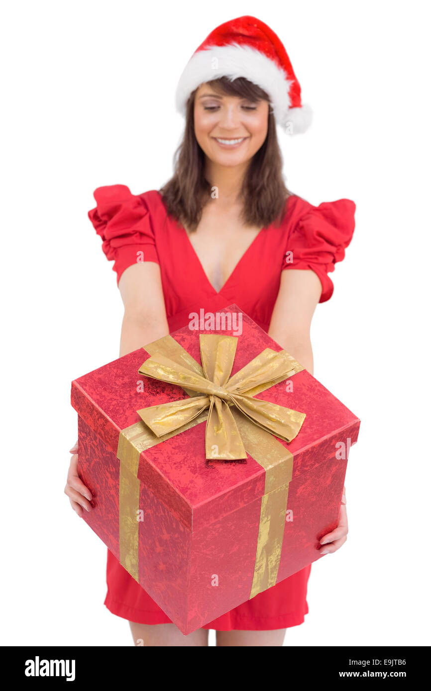 Festive brunette giving a gift Stock Photo