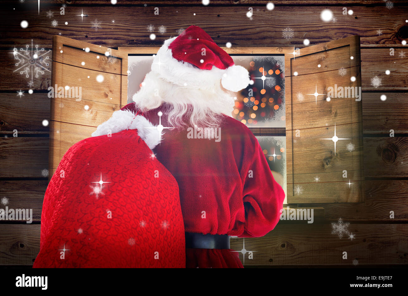 Composite image of santa claus carrying sack Stock Photo - Alamy