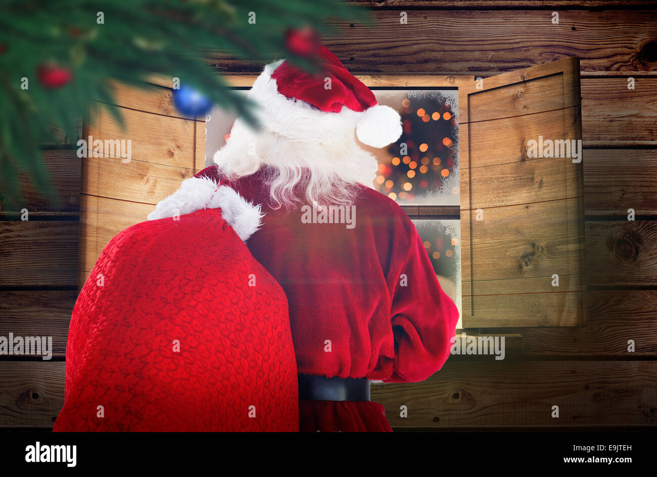 Composite image of santa claus carrying sack Stock Photo - Alamy