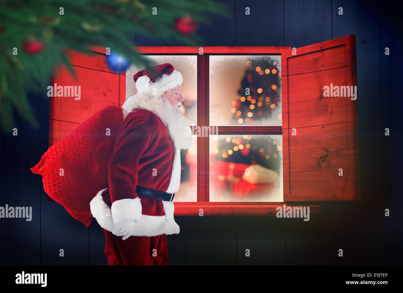 Composite image of santa claus carrying sack Stock Photo - Alamy