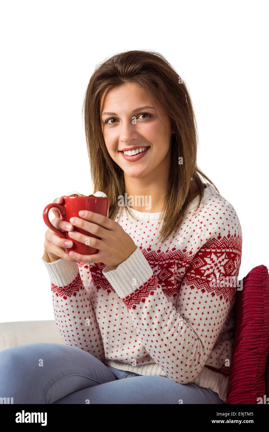 Happy young woman sitting on sofa holding mug Stock Photo - Alamy
