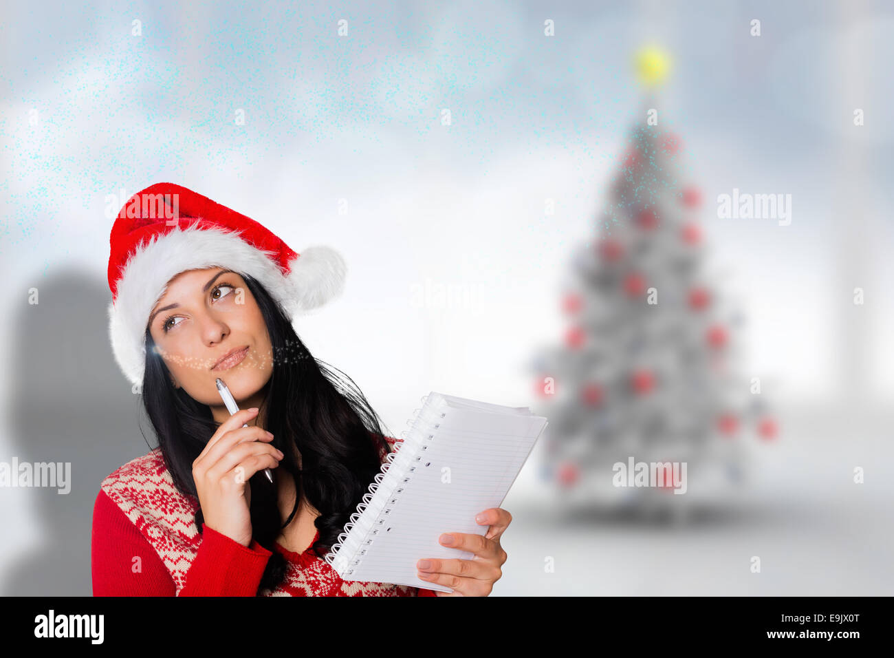 Composite image of woman thinking what to write Stock Photo