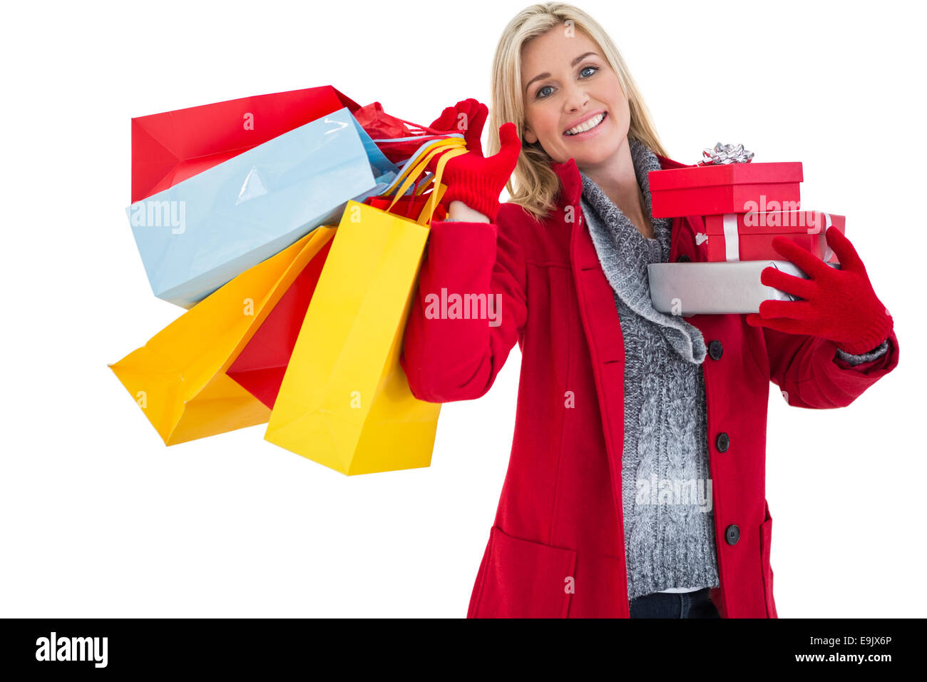 Festive blonde holding many gifts Stock Photo