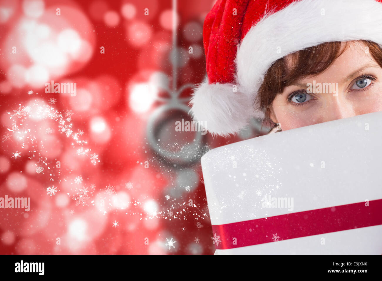 Composite image of woman holding a christmas present Stock Photo - Alamy