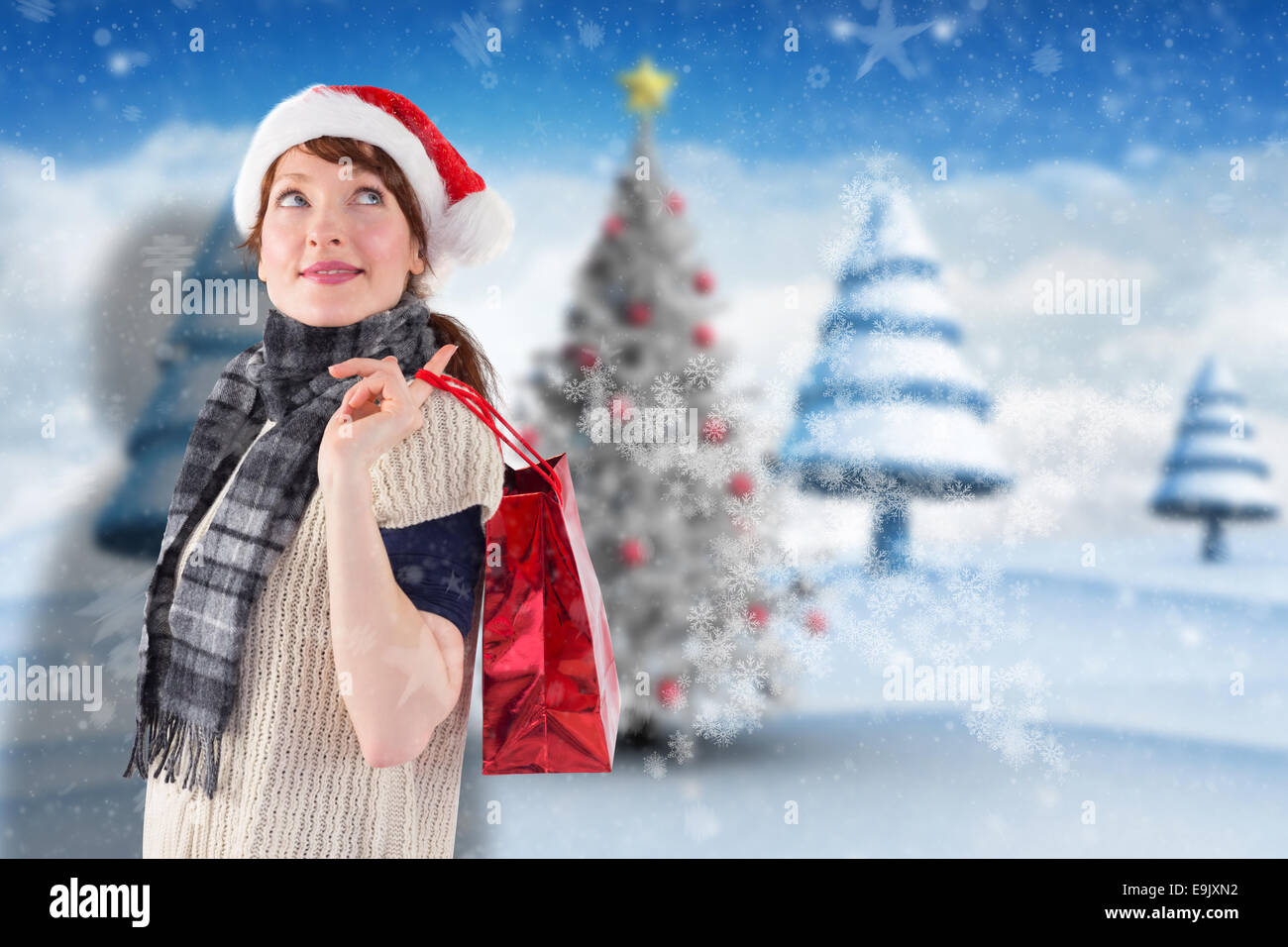 Composite image of smiling woman wearing santa hat Stock Photo - Alamy