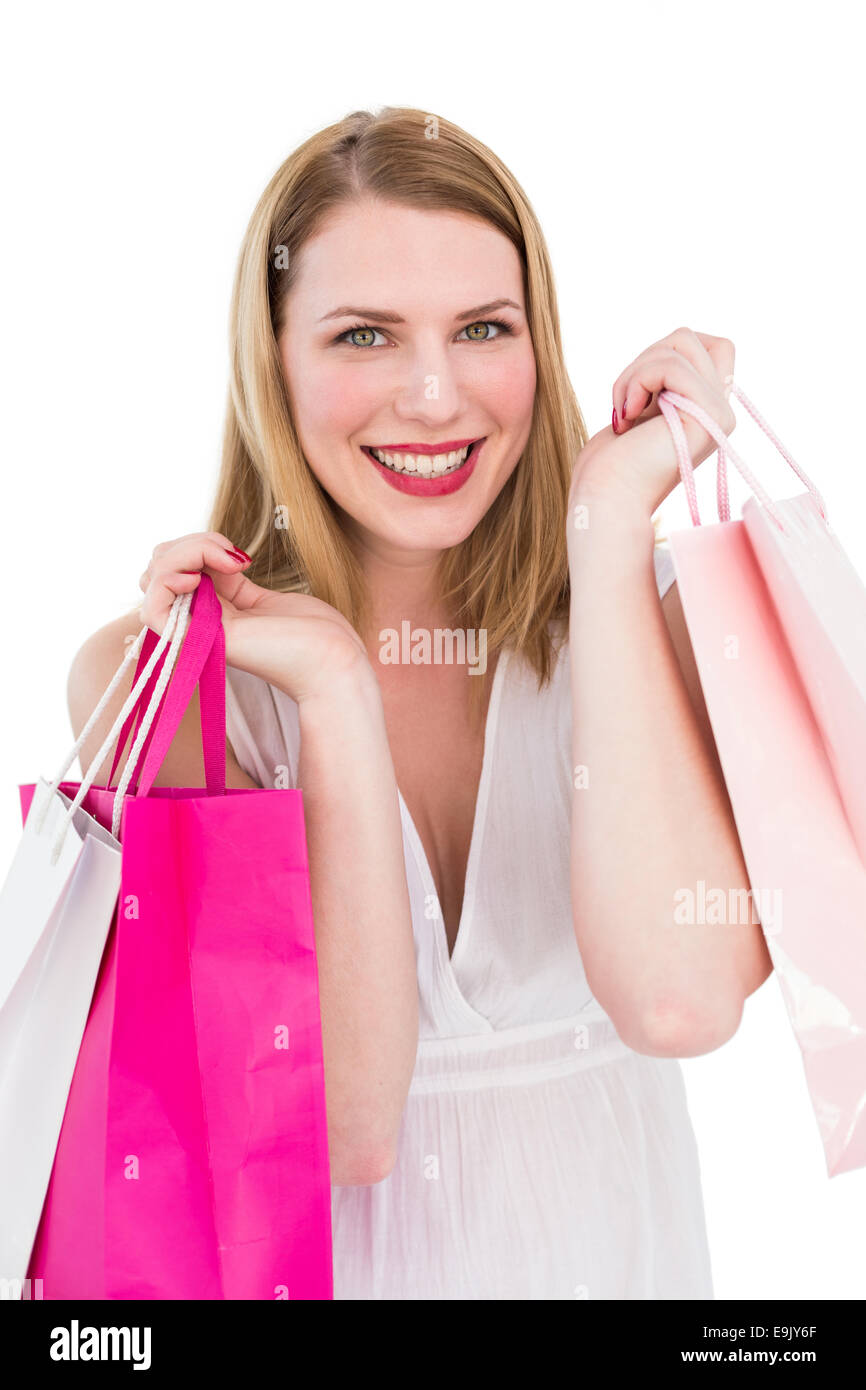 Cheerful blonde woman holding shopping bags Stock Photo - Alamy