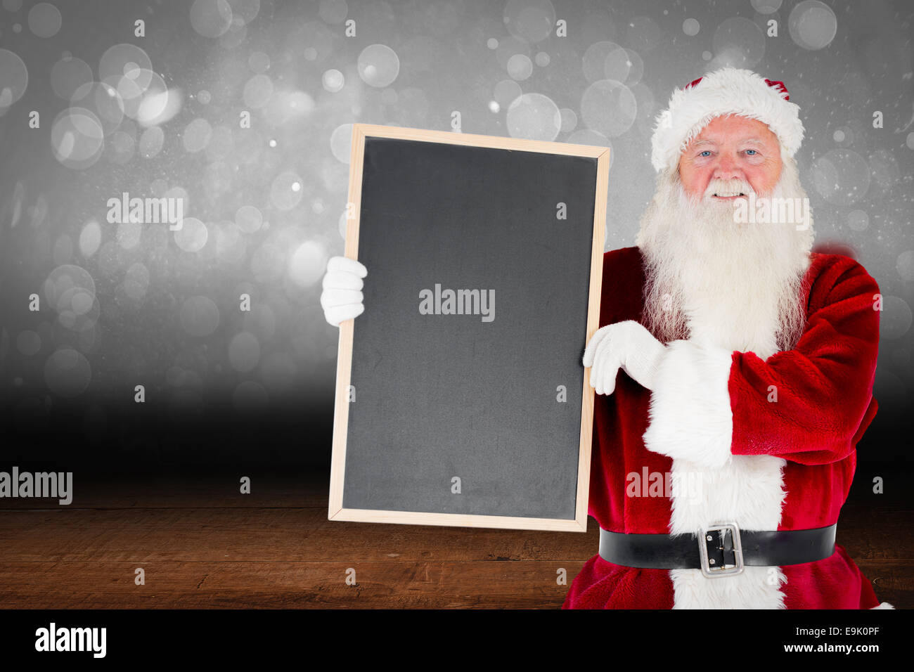 Composite image of santa claus showing blackboard Stock Photo - Alamy