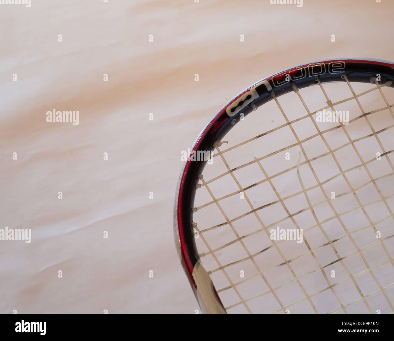 Broken strings on  a Wilson ncode squash racket. Stock Photo