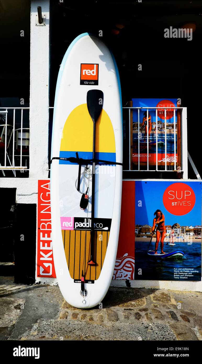 SUP.Stand up paddle board outside a surf shop St Ives Cornwall England uk Stock Photo
