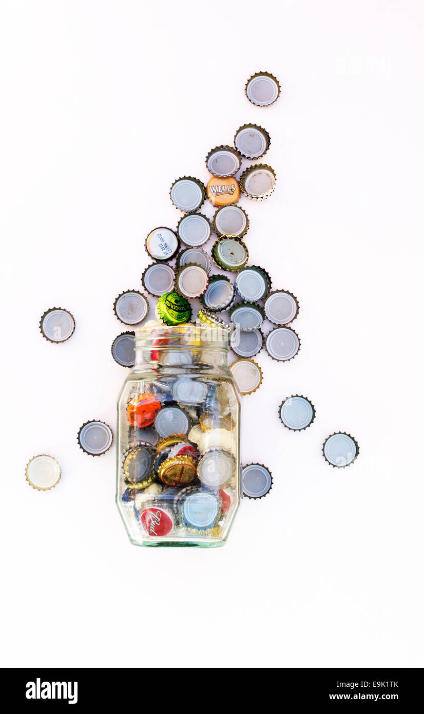 Bottle top falling into a glass jar Stock Photo