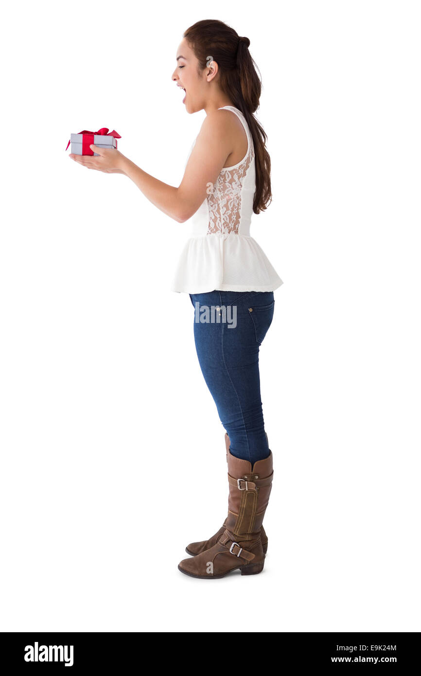 Surprised brunette holding a present Stock Photo