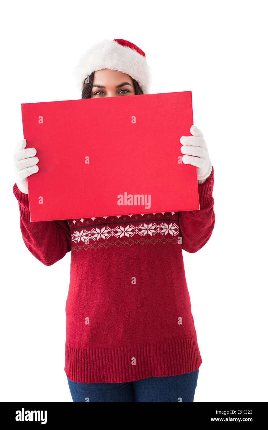 Brunette in winter clothes holding sign Stock Photo