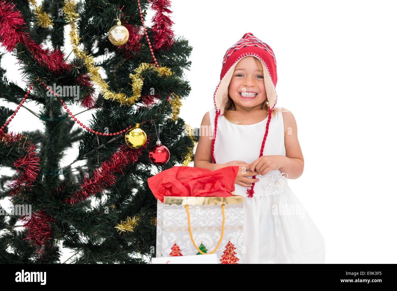 Festive little girl smiling at camera with gifts Stock Photo - Alamy
