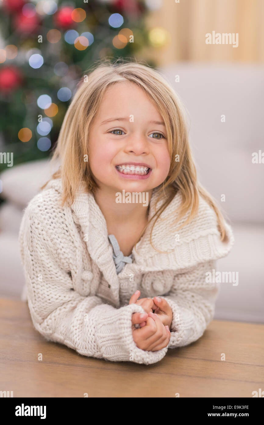 Festive little girl smiling at coffee table Stock Photo