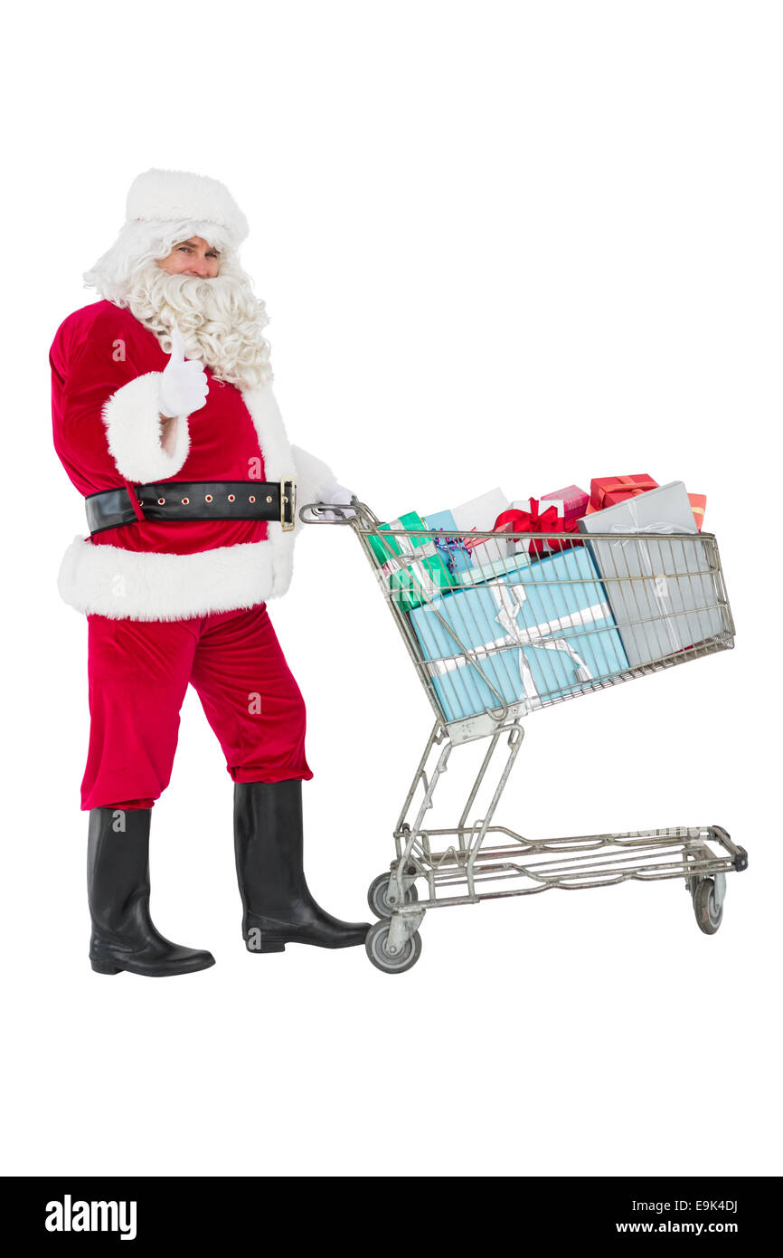 Positive santa delivering gifts with a trolley Stock Photo Alamy