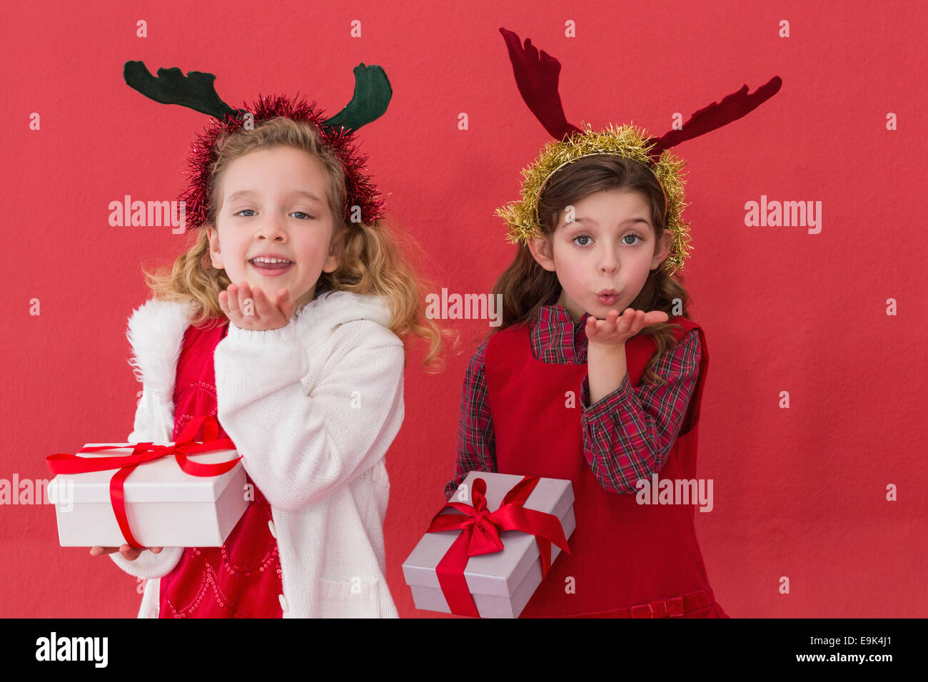 Festive little girls holding gifts Stock Photo