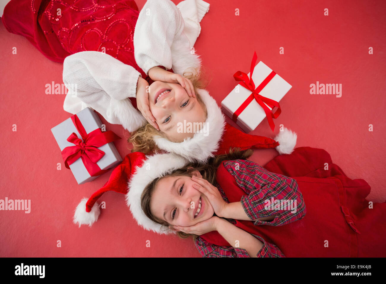 Festive little girls smiling at camera with gifts Stock Photo - Alamy