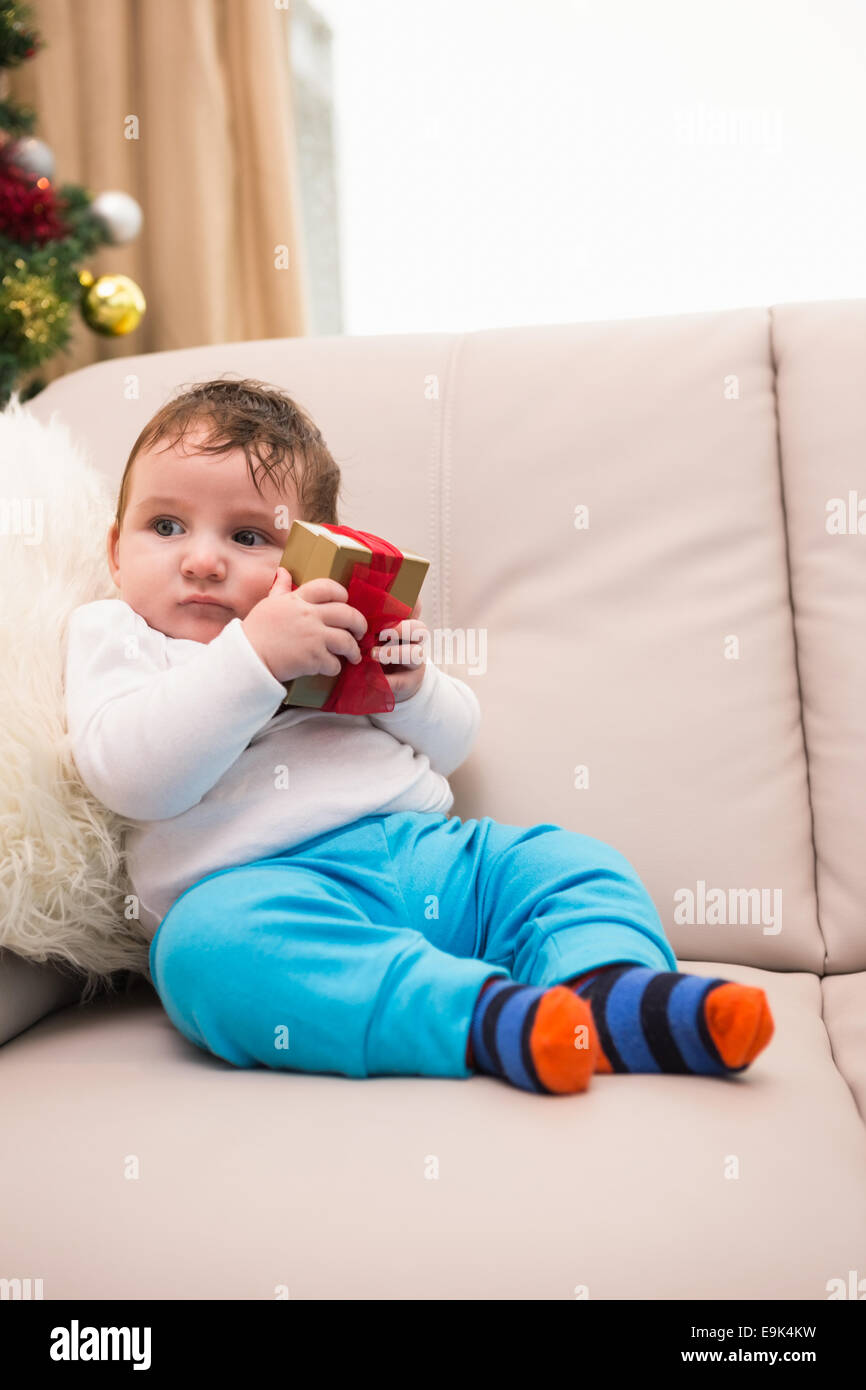 Cute baby boy on the couch at christmas Stock Photo