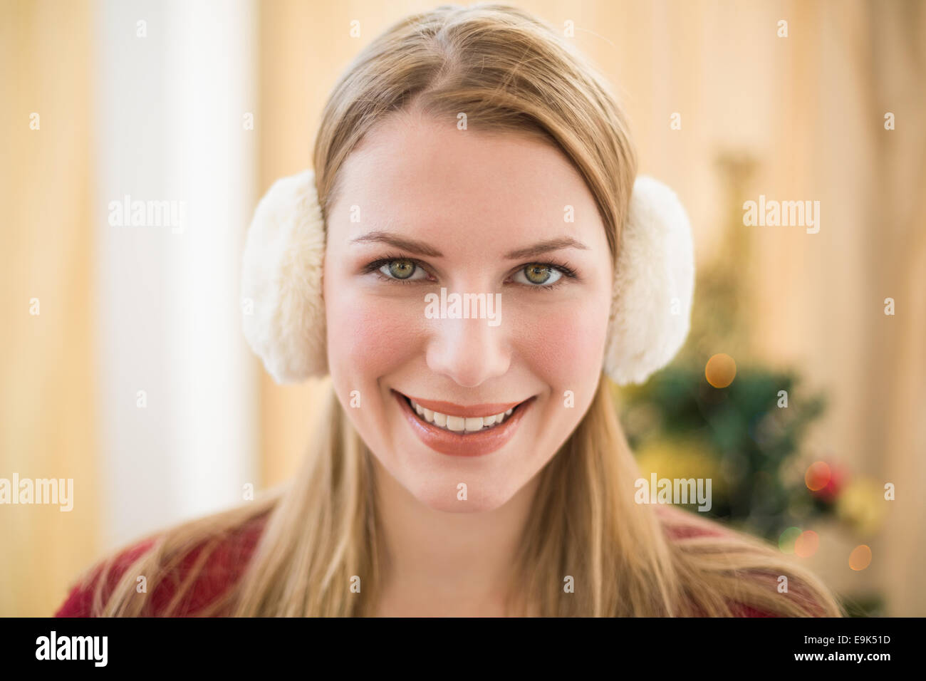 Portrait of a smiling blonde wearing earmuffs Stock Photo