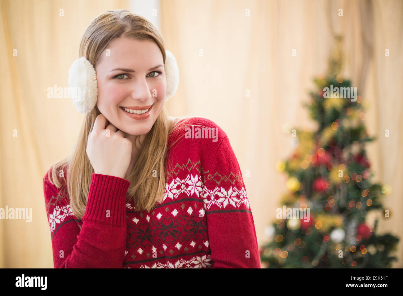 Portrait of a pretty smiling blonde wearing earmuffs Stock Photo
