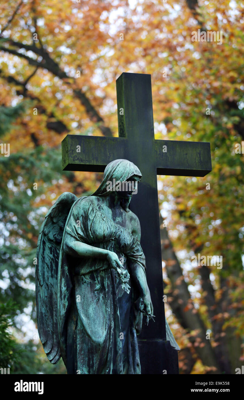 Cologne, Germany. 29th Oct, 2014. An autumn leaves behind a headstone in the Melaten cemetery in Cologne, Germany, 29 October 2014. 1 November 2014 is All Saints' Day. Credit:  dpa picture alliance/Alamy Live News Stock Photo