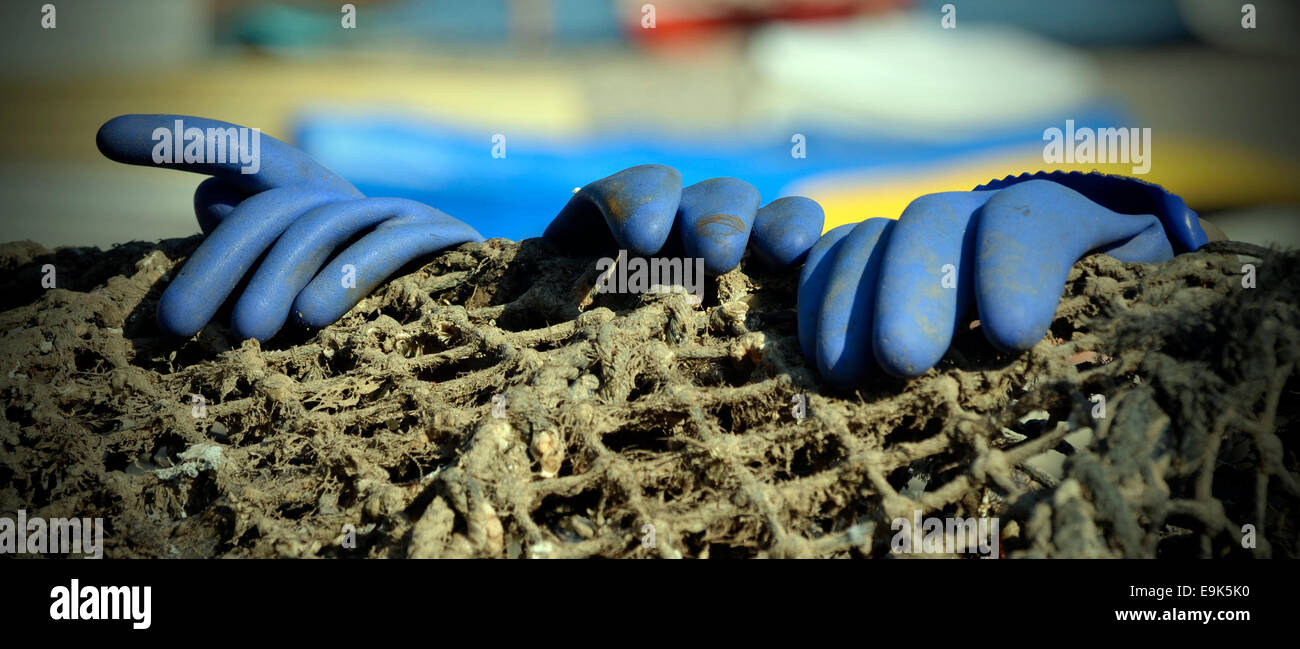rubber gloves on fishing net Stock Photo Alamy