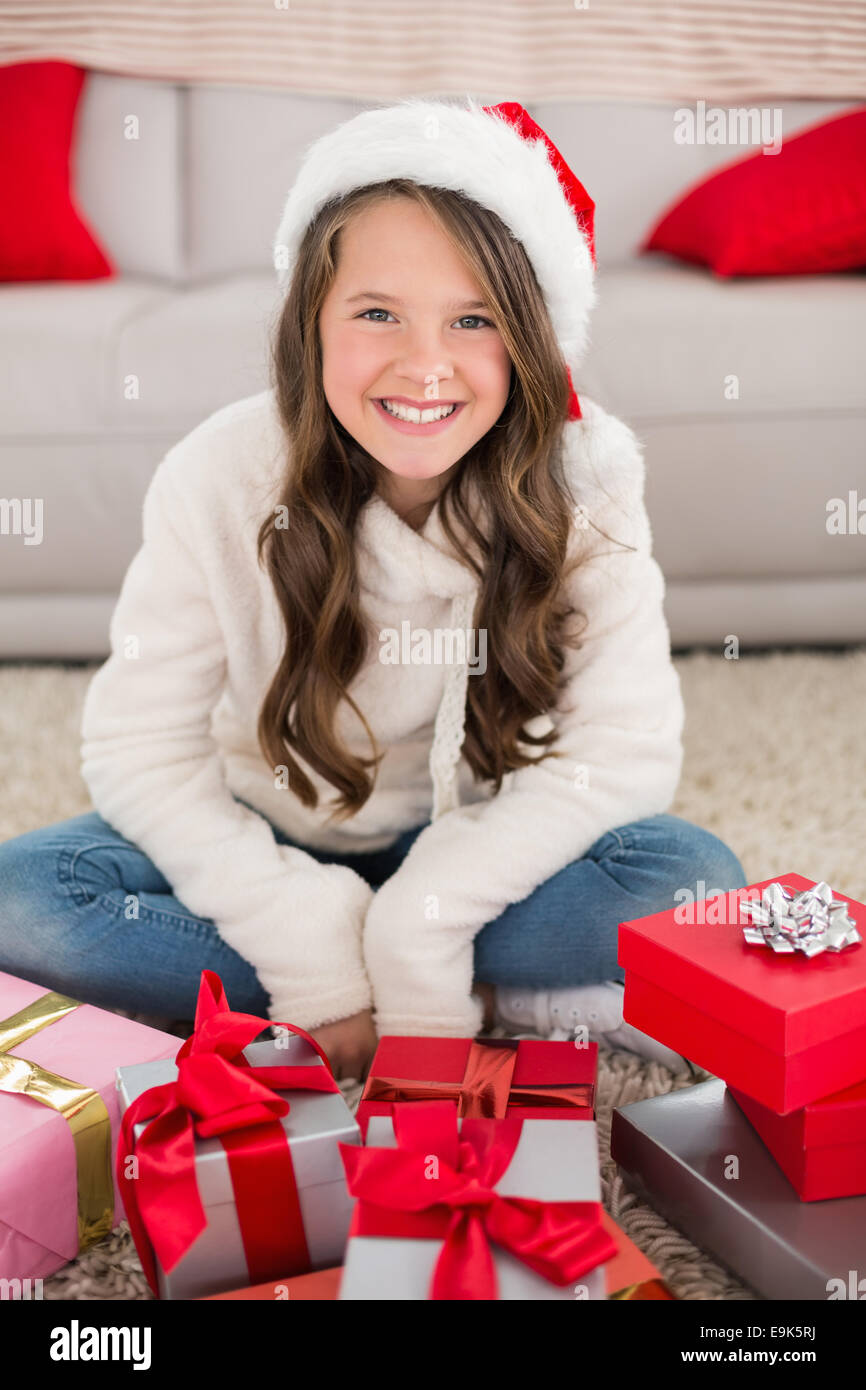 Festive little girl smiling at camera with gifts Stock Photo - Alamy