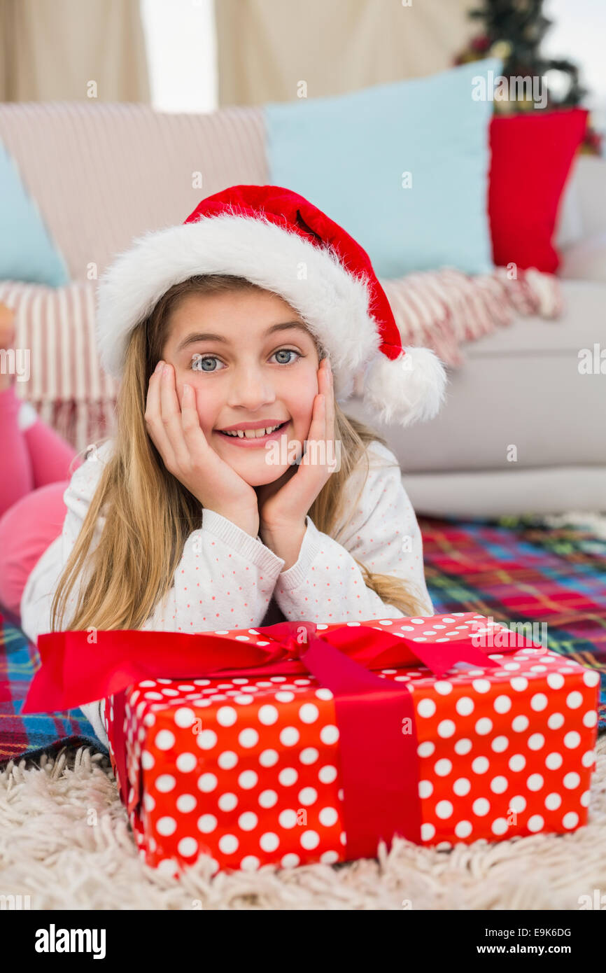 Festive little girl smiling at camera with gift Stock Photo - Alamy