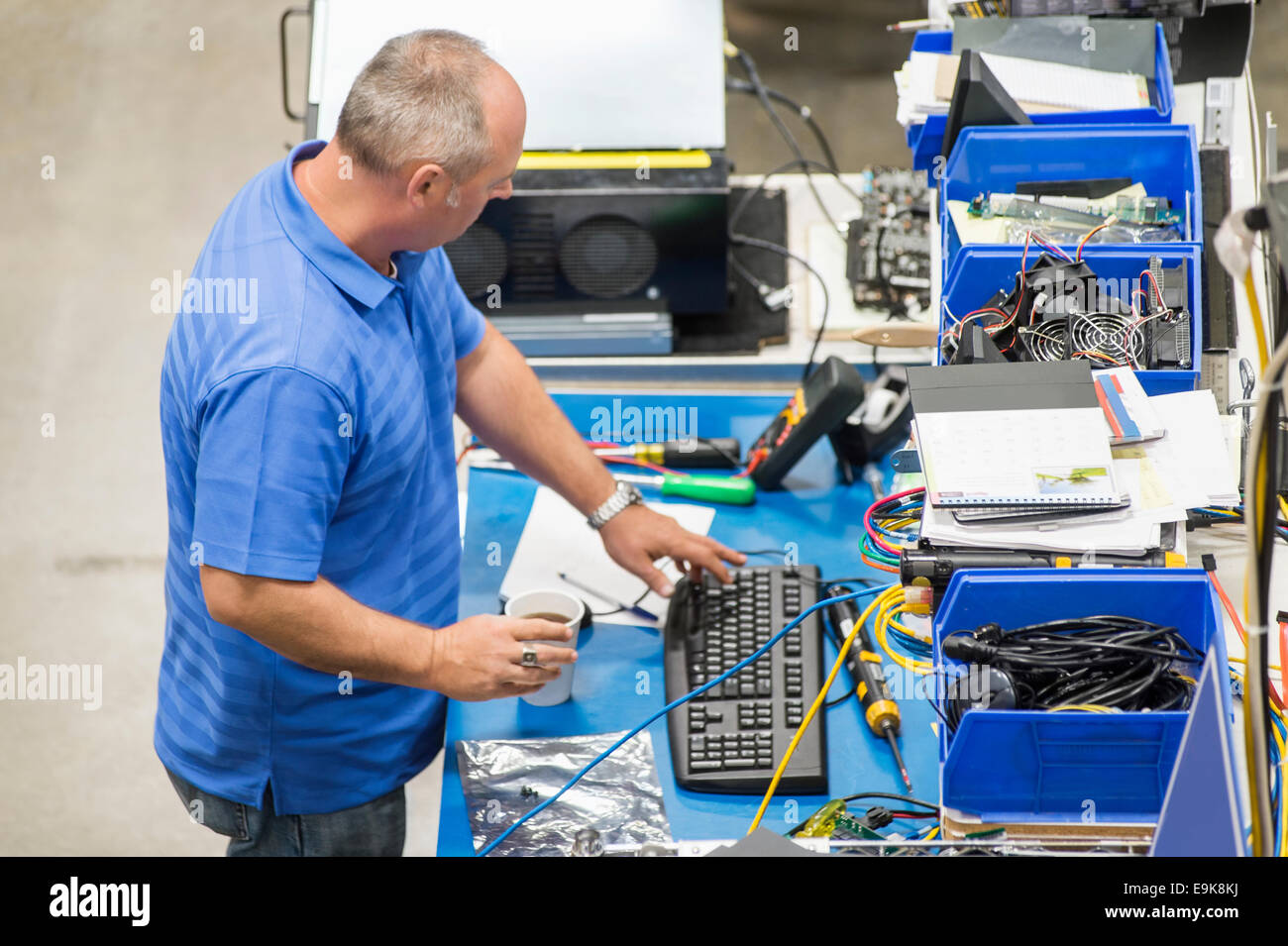 High angle view of mature male engineer working at desk in computer manufacturing industry Stock Photo