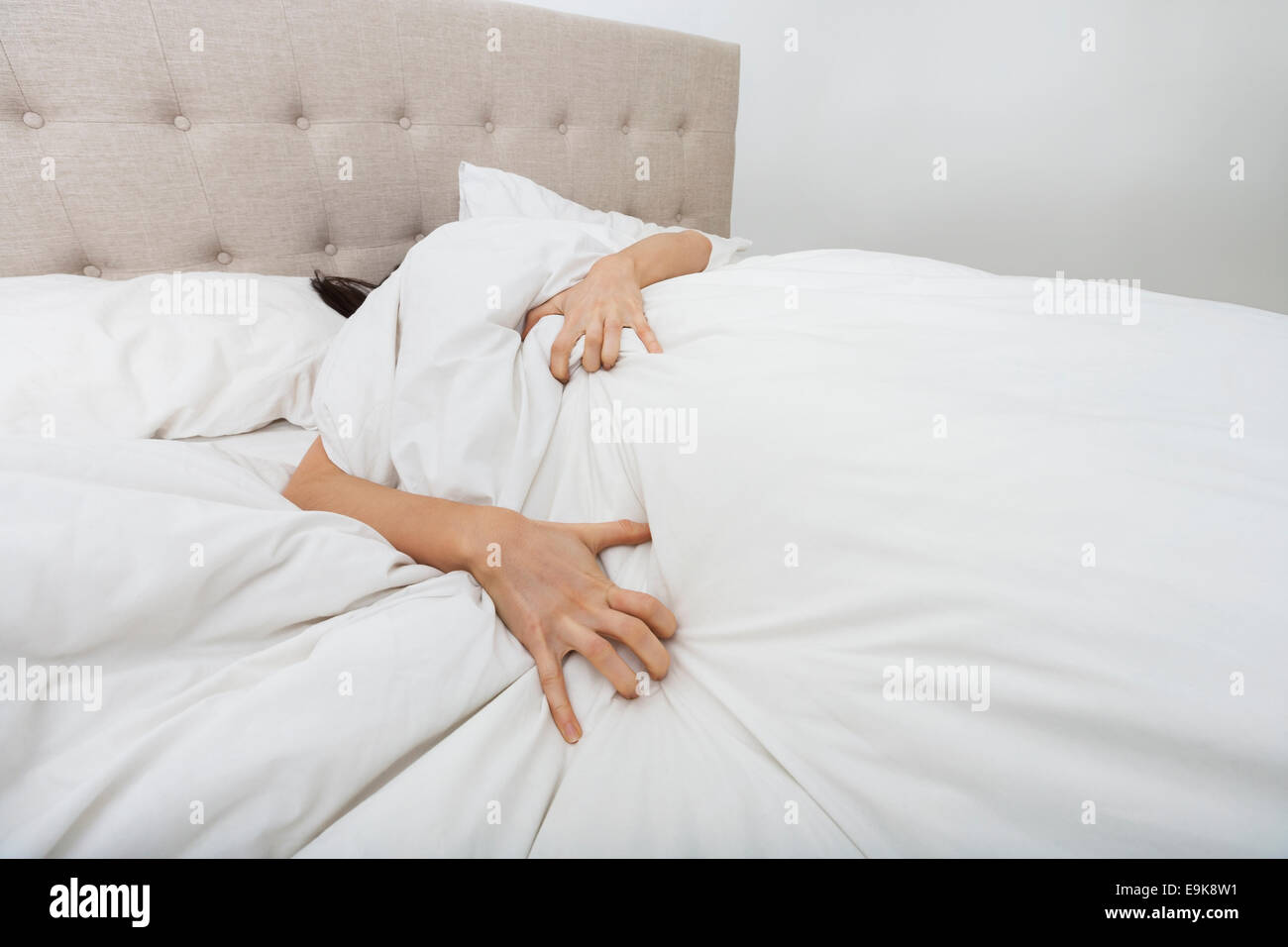 Sacred woman lying in bed Stock Photo