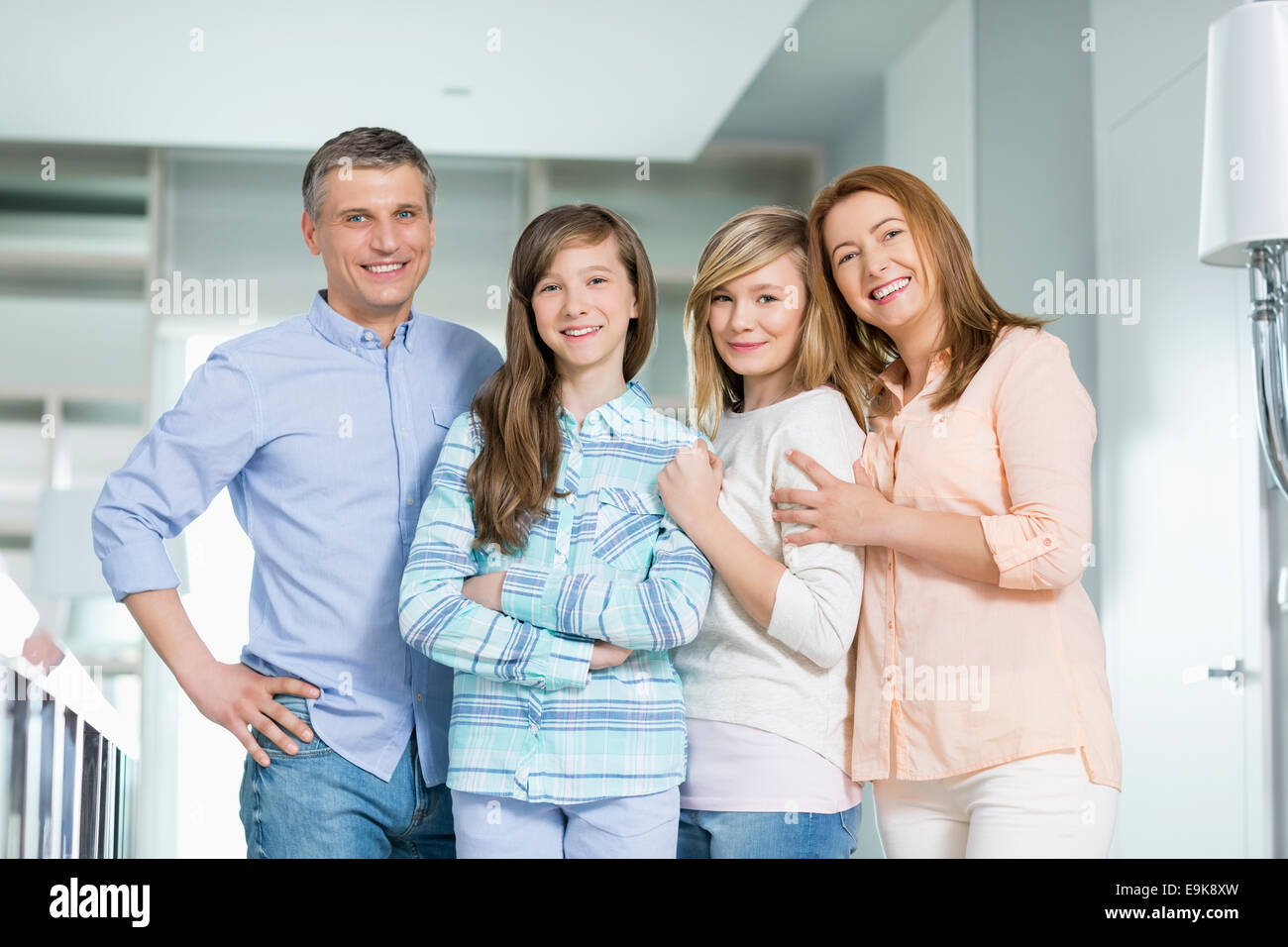 Portrait of happy family with children standing together at home Stock Photo