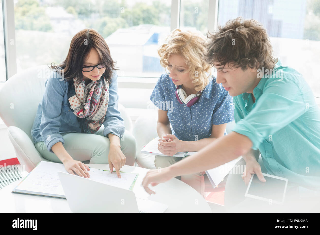Creative businesspeople discussing at table in creative office Stock Photo