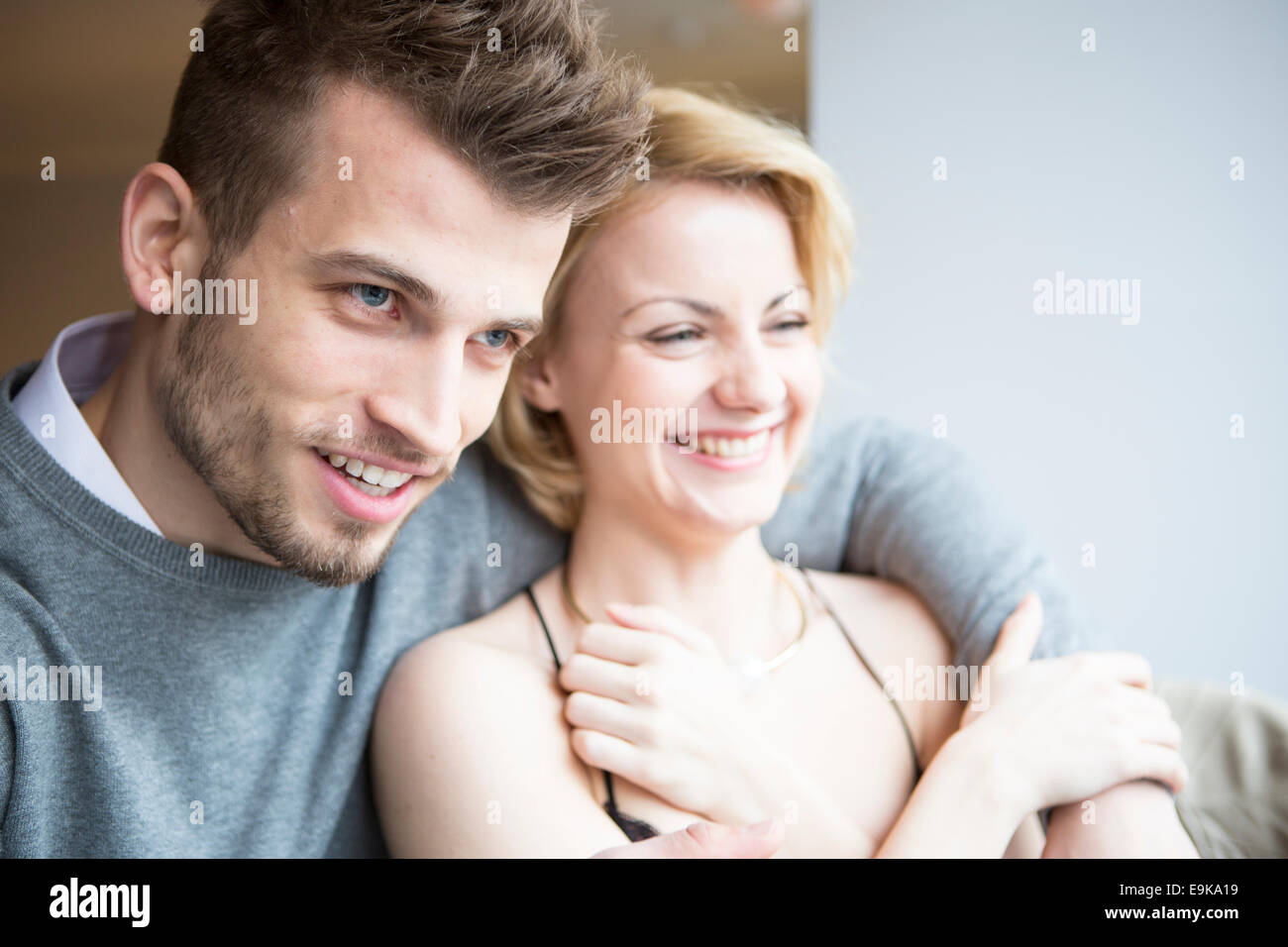 Happy young couple looking away in cafe Stock Photo