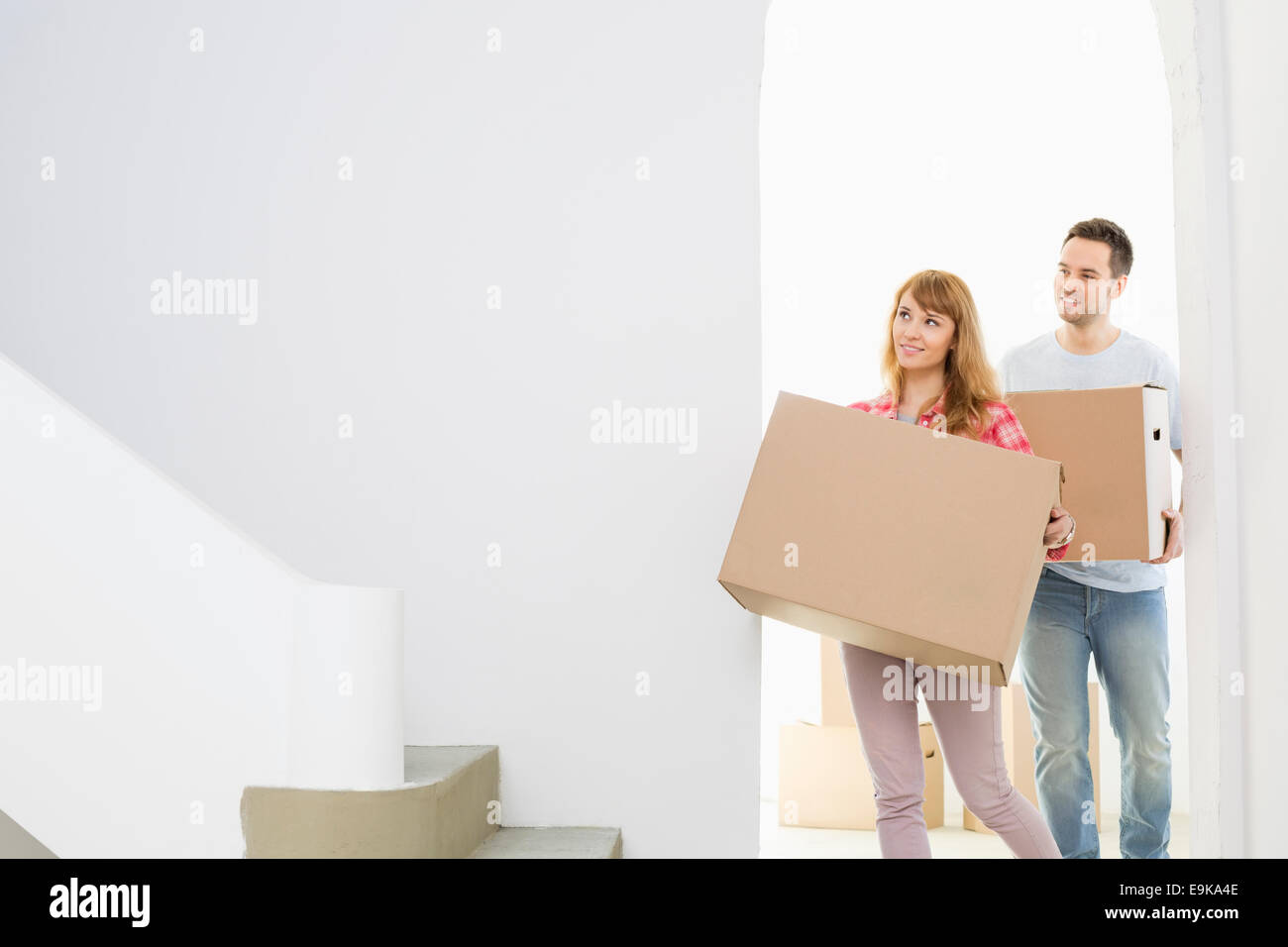 Couple carrying moving boxes Stock Photo
