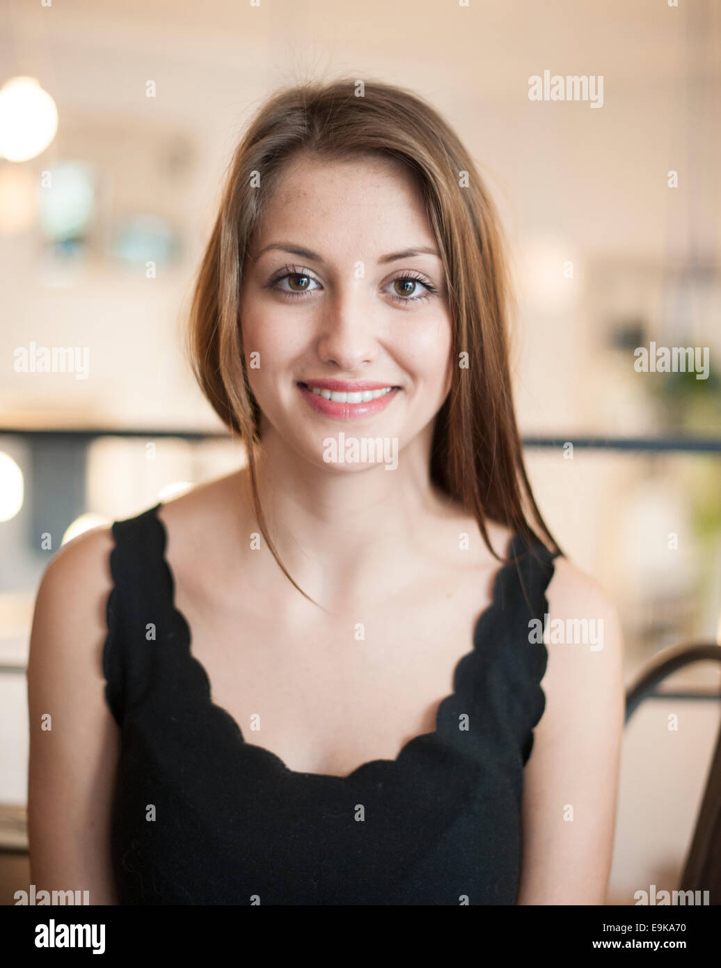 Portrait of beautiful young woman smiling at cafe Stock Photo - Alamy