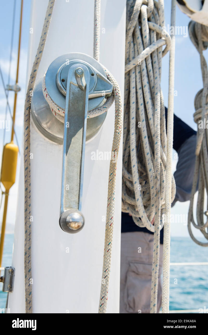 Winch handle and rope on yacht Stock Photo