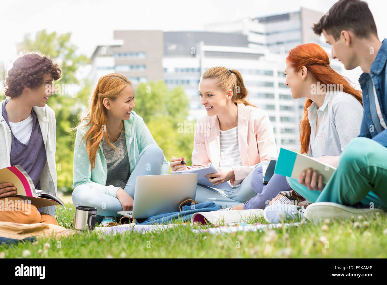 University students studying together on grass Stock Photo