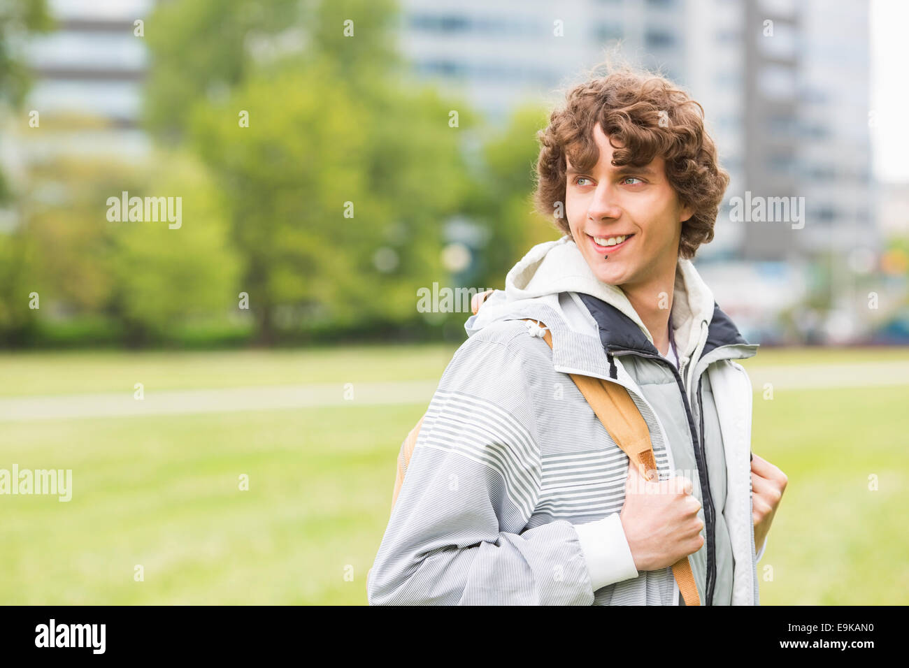 Smiling young male university student at college campus Stock Photo