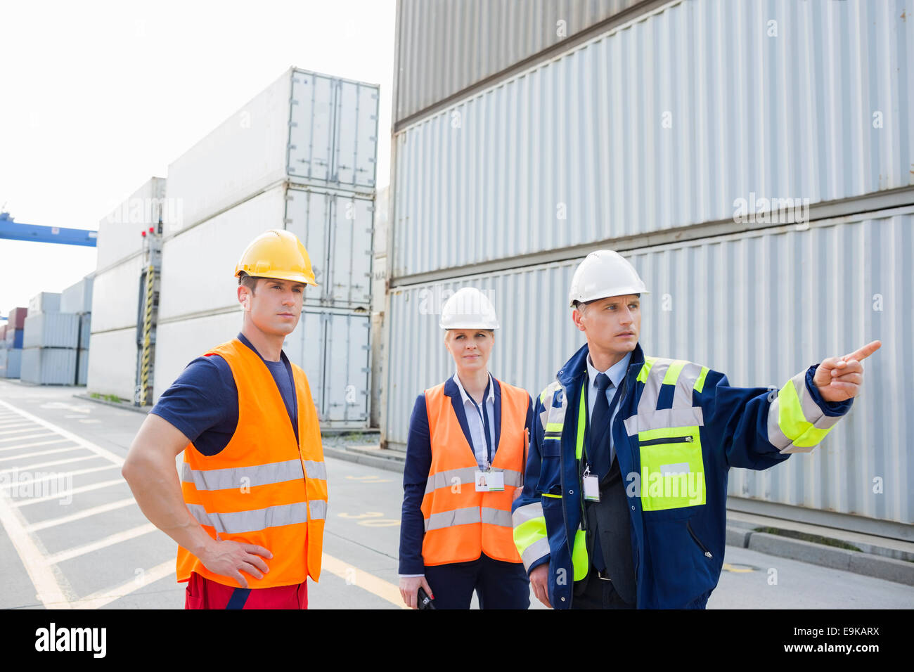 Workers discussing in shipping yard Stock Photo