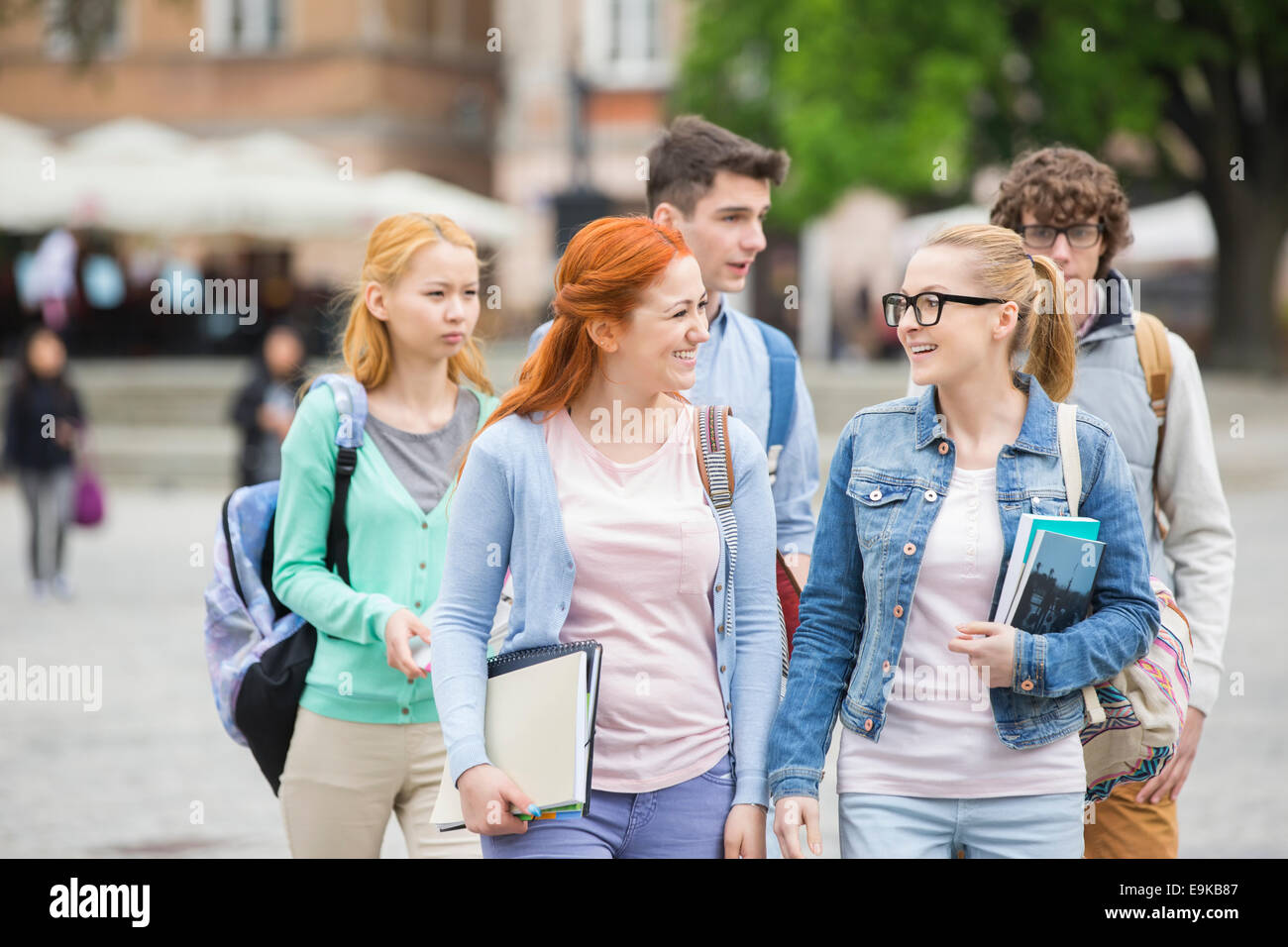 Group of college friends walking outdoors Stock Photo
