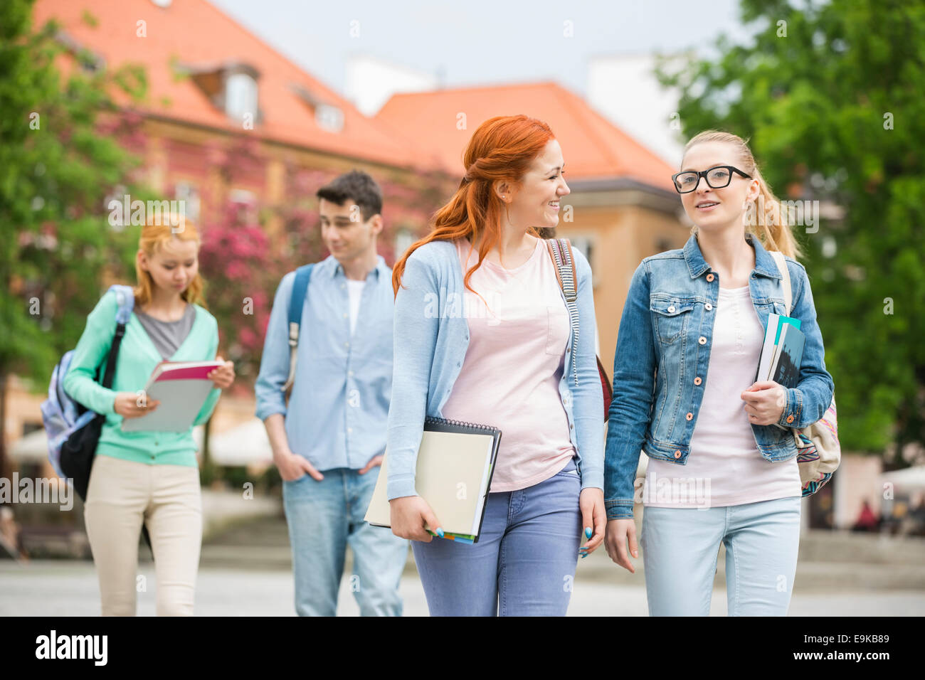 Young university friends walking on street Stock Photo