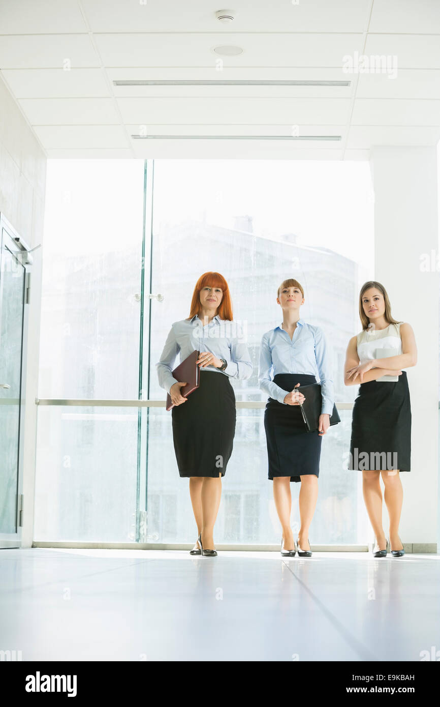 Full-length of confident businesswomen standing in office Stock Photo ...