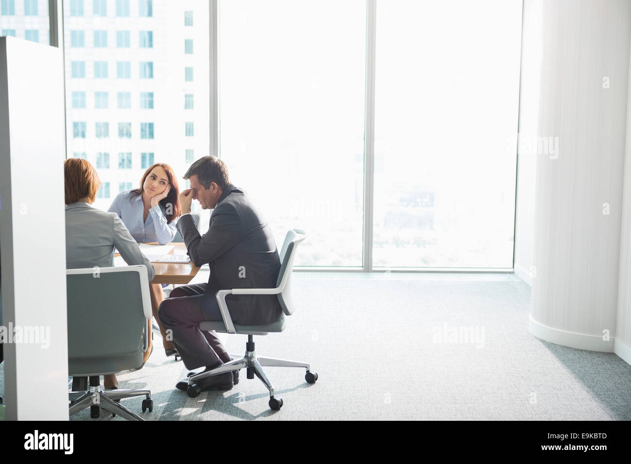 Exhausted businesspeople in meeting Stock Photo